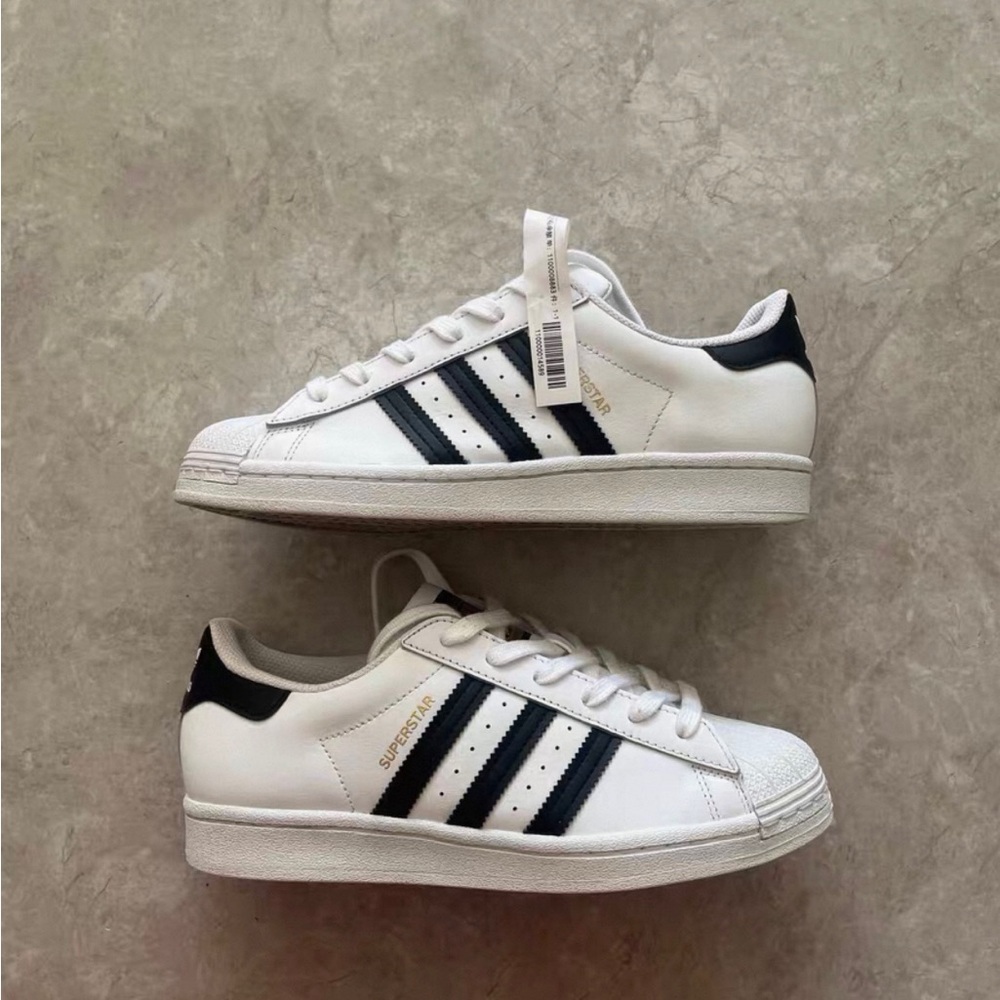 Adidas Women's White Sneakers with Black Stripes